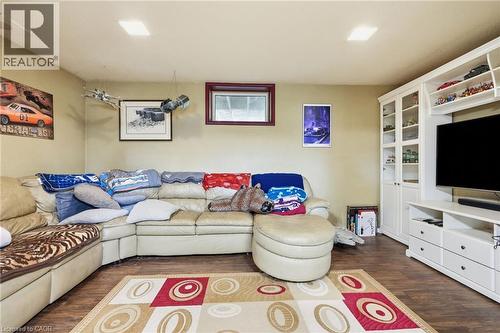Recessed ceiling lighting, wood-finish flooring, built-in white cabinetry, built-in white media center, and a framed window - 1311 W Concession 6 Road, Flamborough, ON 