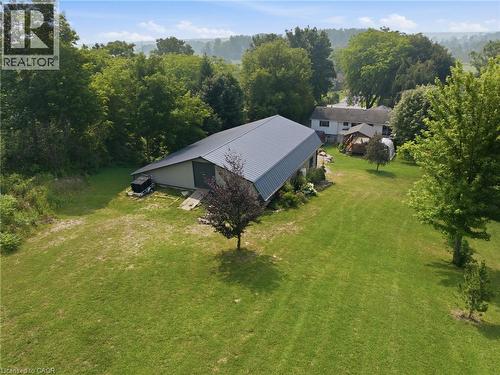 Expansive green lawn with mature trees and a detached structure featuring a metal roof - 1311 W Concession 6 Road, Flamborough, ON 
