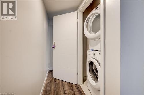 Integrated laundry closet featuring a stacked washer and dryer - 338 Albert Street Unit# 114, Waterloo, ON 