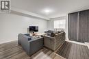 Wood-finish flooring throughout, bright white walls, and a window with roller shade - 338 Albert Street Unit# 114, Waterloo, ON 
