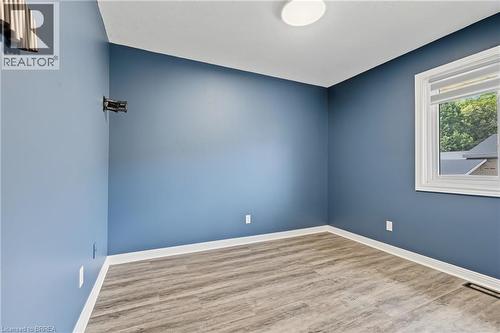 Room with wood-finish flooring, a single window, and a ceiling-mounted light fixture - 141 Race Street, Paris, ON 