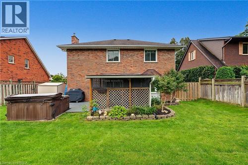 Brick exterior with a covered patio area and an integrated garden bed - 141 Race Street, Paris, ON 