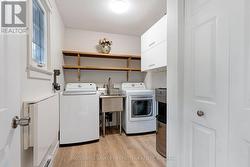 Main floor laundry with extra shelving and sink - 