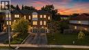 Brick facade exterior with multiple window styles, integrated garages, and a front lawn - 123 Brickyard Way, Brampton, ON 