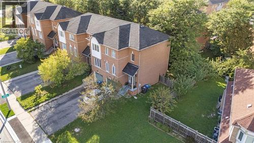 Brick exterior with multiple windows, black shingle roof, and an attached garage - 123 Brickyard Way, Brampton, ON 