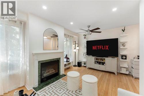 Fireplace with a green stone surround and white mantel - 123 Brickyard Way, Brampton, ON 