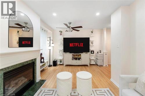 Hardwood flooring, recessed lighting, and a built-in fireplace with a stone surround - 123 Brickyard Way, Brampton, ON 