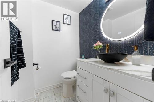 Vanity with white cabinetry, light-toned countertop, and a black vessel sink - 123 Brickyard Way, Brampton, ON 