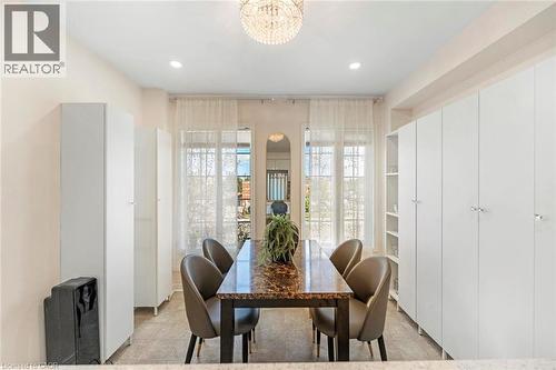 Integrated white cabinetry, recessed lighting, and a decorative chandelier - 123 Brickyard Way, Brampton, ON 
