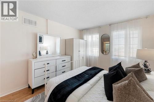 Wood-finish flooring with white base trim - 123 Brickyard Way, Brampton, ON 