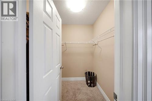 Walk-in closet featuring wire shelving, neutral carpeting, and a flush mount ceiling light - 167 Broadoaks Drive, Cambridge, ON 