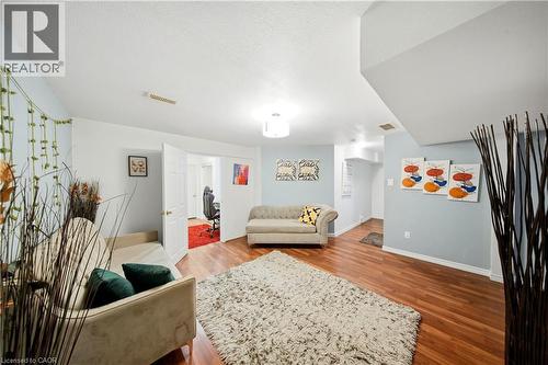 Wood-finish flooring throughout, complemented by light-toned wall finishes and recessed lighting - 167 Broadoaks Drive, Cambridge, ON 