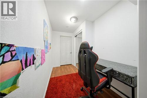 Wood-finish flooring, white walls, and a built-in desk area with a sliding closet - 167 Broadoaks Drive, Cambridge, ON 