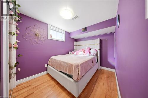 Wood-finish flooring throughout, white trim, and a window with blinds - 167 Broadoaks Drive, Cambridge, ON 