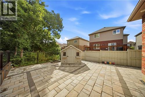 Expansive patio featuring multi-toned paver stones and a decorative border - 167 Broadoaks Drive, Cambridge, ON 