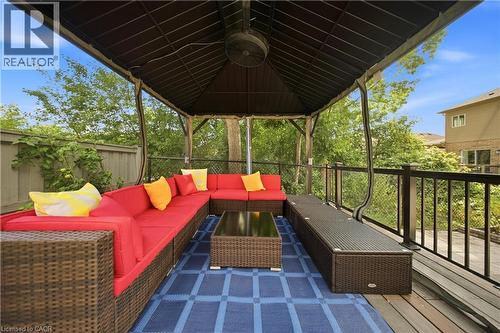 Expansive outdoor deck featuring a covered gazebo with a ceiling fan, durable wood decking, and a privacy fence - 167 Broadoaks Drive, Cambridge, ON 