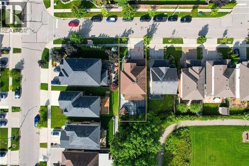 Residential property featuring a private backyard, mature trees, adjacent green space, and proximity to paved roadways - 167 Broadoaks Drive, Cambridge, ON 