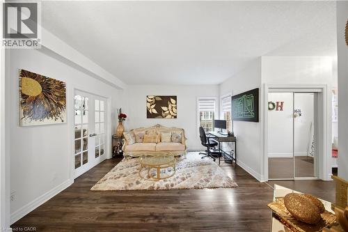 Wood-finish flooring, white walls, and bright white trim - 167 Broadoaks Drive, Cambridge, ON 