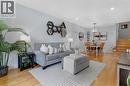 Hardwood flooring, recessed lighting, contemporary wall shelving, chandelier lighting, and a staircase with wood treads - 477 Kingscourt Drive Unit# B, Waterloo, ON 