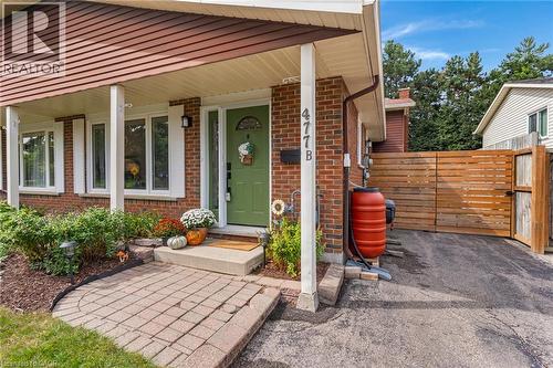 Brick exterior featuring a covered entry with white columns - 477 Kingscourt Drive Unit# B, Waterloo, ON 