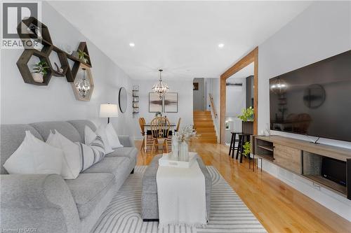 Recessed ceiling lighting, wood-finish flooring, a wood accent doorway, and a built-in media console - 477 Kingscourt Drive Unit# B, Waterloo, ON 