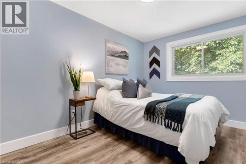 Wood-finish flooring, white trim, and a window with white casing - 477 Kingscourt Drive Unit# B, Waterloo, ON 