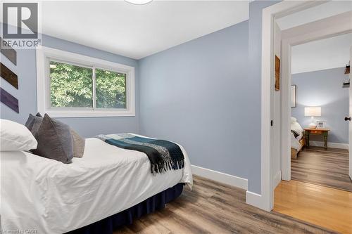 Wood-finish flooring, white trim, recessed lighting, and a white-framed window - 477 Kingscourt Drive Unit# B, Waterloo, ON 