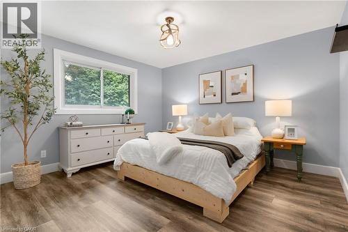 Wood-finish flooring, recessed lighting, and a window with exterior tree views - 477 Kingscourt Drive Unit# B, Waterloo, ON 
