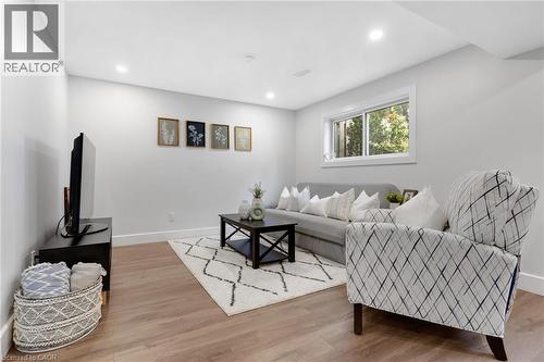 Recessed lighting, wood-finish flooring, white walls, and a window with white trim - 477 Kingscourt Drive Unit# B, Waterloo, ON 