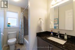 Main floor 4 pc bath with granite counter tops - 