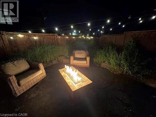 Private patio featuring a stamped concrete surface, wood fencing, and perimeter plantings - 4073 Stadelbauer Drive, Beamsville, ON 