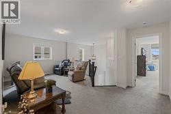 Spacious upper-level landing featuring neutral carpeting and light-toned walls - 