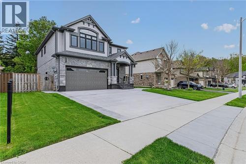 Contemporary two-story residence featuring a gray brick and siding facade - 249 Woodway Trail, Simcoe, ON 