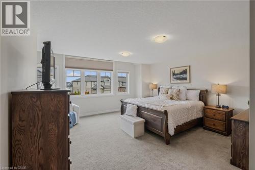 Carpeted room with multiple windows, recessed lighting, and neutral wall tones - 249 Woodway Trail, Simcoe, ON 
