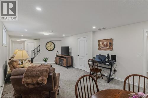 Finished living space with light gray wall paint and matching carpet flooring - 249 Woodway Trail, Simcoe, ON 
