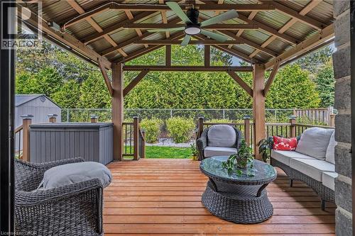 Expansive wood-finish deck featuring a covered gazebo with a corrugated metal roof and exposed wood beams - 249 Woodway Trail, Simcoe, ON 