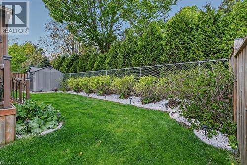 Expansive lawn area featuring a decorative gravel border with shrubbery - 249 Woodway Trail, Simcoe, ON 
