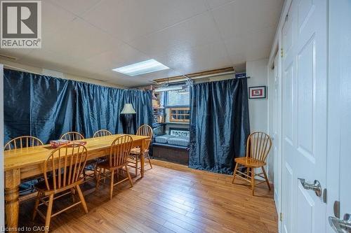 Wood-finish flooring with a drop ceiling and recessed lighting - 123 Mill Street, Delhi, ON 