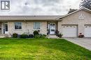 Stone veneer exterior with an attached two-car garage and a paved driveway - 123 Mill Street, Delhi, ON 