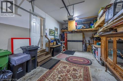 Concrete flooring with built-in overhead storage shelves and a utility door - 123 Mill Street, Delhi, ON 
