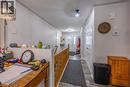 Hallway with wood-finish flooring, white walls, and recessed lighting - 123 Mill Street, Delhi, ON 