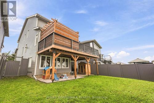 Elevated deck & walkout overlooking the yard - 210 Pingwi Place, Ottawa, ON 