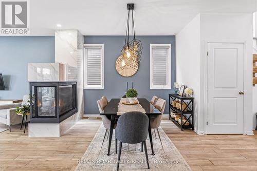 Dining area with statement lighting - 210 Pingwi Place, Ottawa, ON 