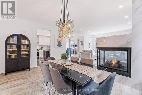 Gas fireplace with floor-to-ceiling tile - 210 Pingwi Place, Ottawa, ON 