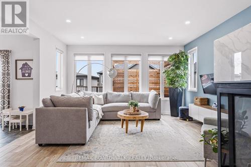 Bright living room with backyard views - 210 Pingwi Place, Ottawa, ON 