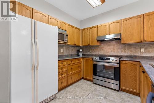 Kitchen with wood cabinetry - 5 Rayburn Street, Ottawa, ON 