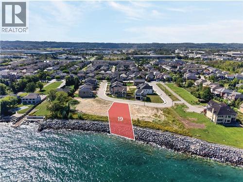 Waterfront lot featuring a rock revetment and clear water - 100 Watershore Drive Unit# 19, Stoney Creek, ON 
