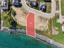 Waterfront lot featuring a natural shoreline and surrounding residences - 
