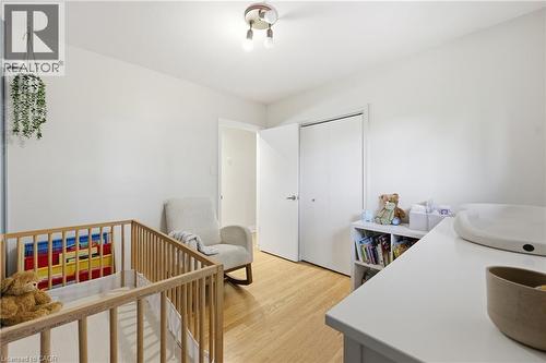 Recessed ceiling light, wood-finish flooring, white walls, and built-in closet with bi-fold doors - 312 Upper Paradise Road, Hamilton, ON 