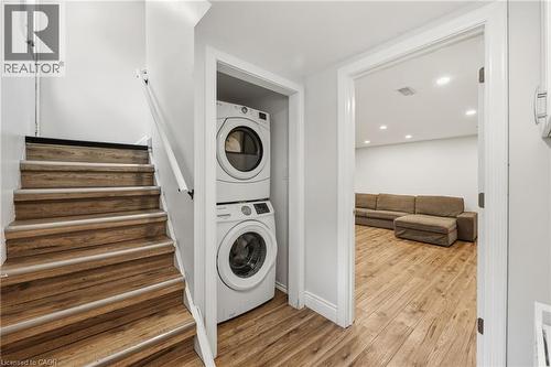 Wood-finish flooring throughout, stacked laundry appliances, and recessed lighting - 312 Upper Paradise Road, Hamilton, ON 